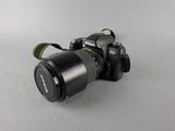 a camera with a lens attached to it on a table