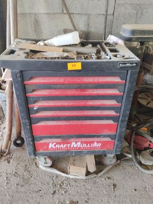 a red and black tool box sitting in a garage