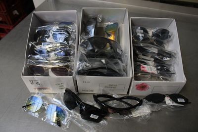 three boxes of assorted items sitting on a table