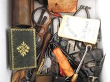 a white box filled with assorted items including scissors and other items