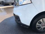 a white car that is parked on the side of the road