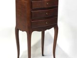 an image of a small wooden table with drawers