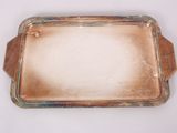 an old silver tray with a glass lid on a white surface