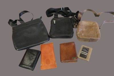 many different types of purses and wallets laid out on a table