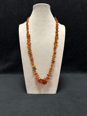 a necklace made of raw baltic amber beads on a mannequin