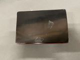 a small metal object on a table with a white table cloth