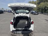 cars are parked in a parking lot with the back of the car open