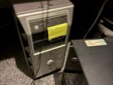 a computer on a desk with a yellow sticker on it