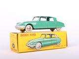 a green toy car sitting on top of a yellow box