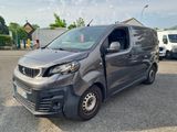 a grey van that is parked in a parking lot