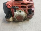 a red and black engine sitting on the floor