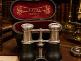 an old pair of binoculars sitting on top of a table next to a book