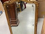 a mirror that is sitting on the floor in a room