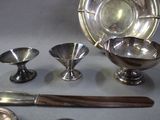 a lot of silver items that are sitting on a table