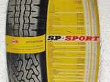 a close up of a tire on a wall with a sticker