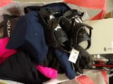 a pile of clothes and a laptop on a table