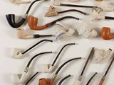 many different types of pipe holders on the table