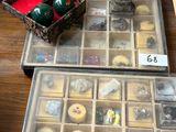 two trays of candles and a box of candles on a table