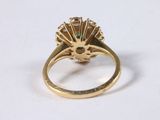 an image of a close up of a gold ring on a white surface