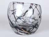 a close up of a glass vase on a white surface