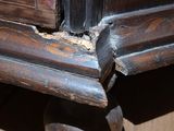 a close up of a wooden cabinet with a hole in it
