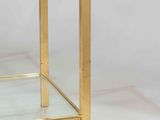 a glass and brass side table with a glass top