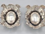 pair of silver shell earrings with pearl in center