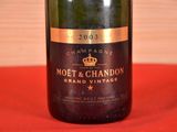 a bottle of champagne sitting on a red cloth