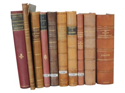 many old books lined up on a shelf together