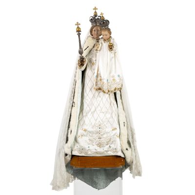an image of a statue of the virgin of guadalupe on a pedestal