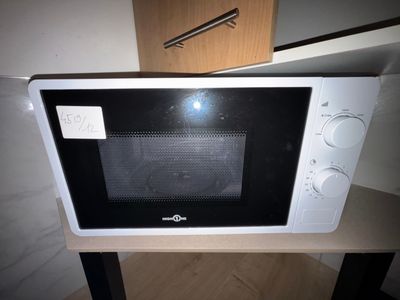 a microwave that is sitting on a table in a room