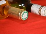 two bottles of wine on a red table cloth