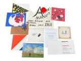 many cards and postcards on a white surface