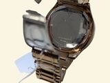 a close up of a watch on a metal bracelet
