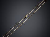 a gold chain with a heart charm on it
