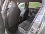 the back seats of a car with the door open and the driver ' s seat down