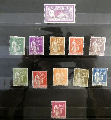 several different colored stamps are on display in a glass case