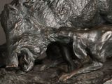a statue of a boar and a baby boar on a rock