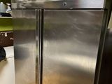 a silver refrigerator in a kitchen next to a washing machine