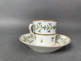 an image of a white cup and saucer with blue flowers on it