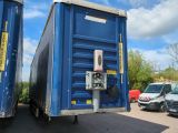 two blue shipping containers sitting next to each other in a parking lot