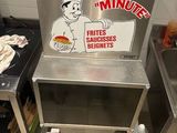 a machine that has a sign on it in a kitchen