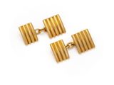 two pairs of gold cufflinks on a white background