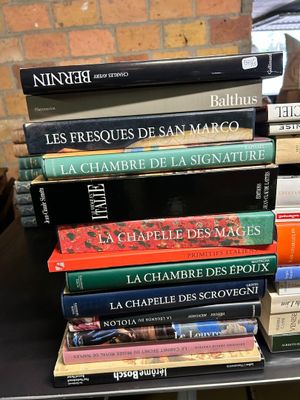 many books stacked on top of each other on a table