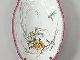 a white plate with a dragonfly and flowers on it