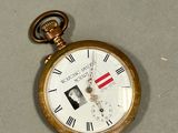 a gold pocket watch with roman numerals on it
