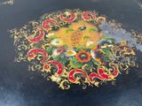 a black table with a gold and red design on it