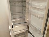 a white refrigerator with its door open in a room