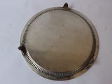 an antique silver plate on a white table with a white background