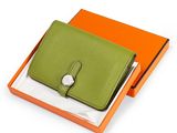 an orange and green box with a green wallet inside of it